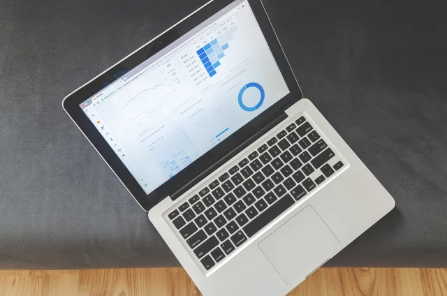 Overhead view of a laptop showing data visualizations and charts on its screen. Cross-border technical SEO for UK firms after Brexit